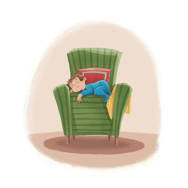 A little boy asleep in a big green armchair