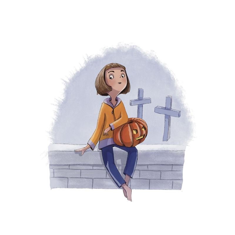 A girl with a carved pumpkin sits on a wall by a graveyard