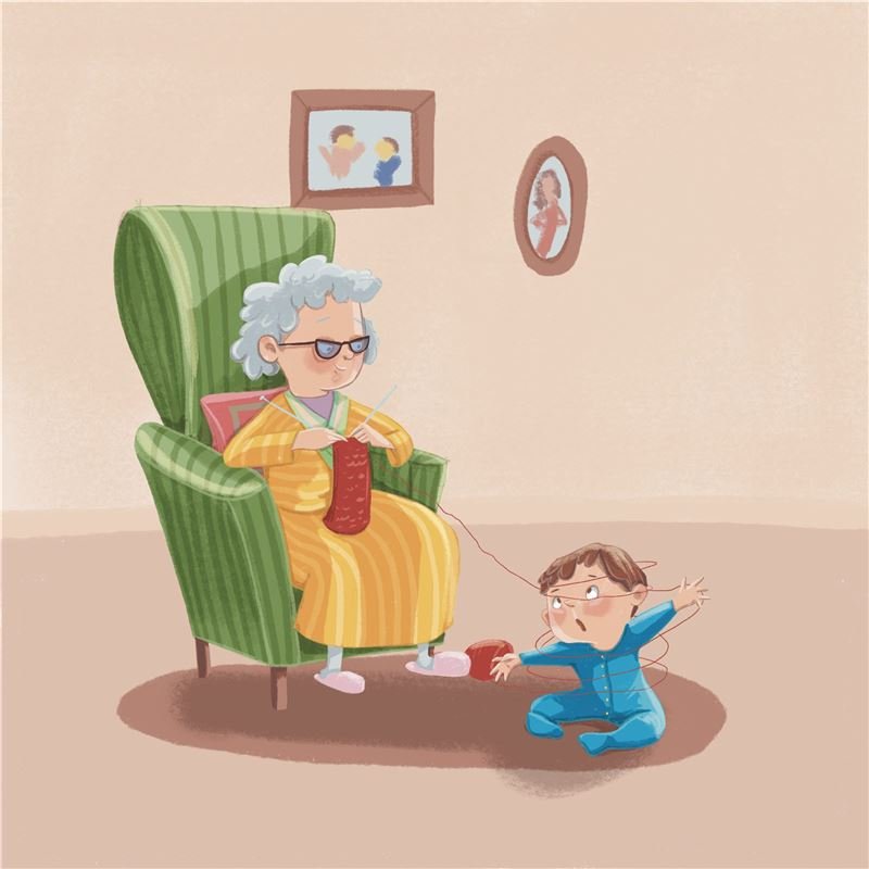 A grandma knits in a green armchair while a toddler tangles her red yarn